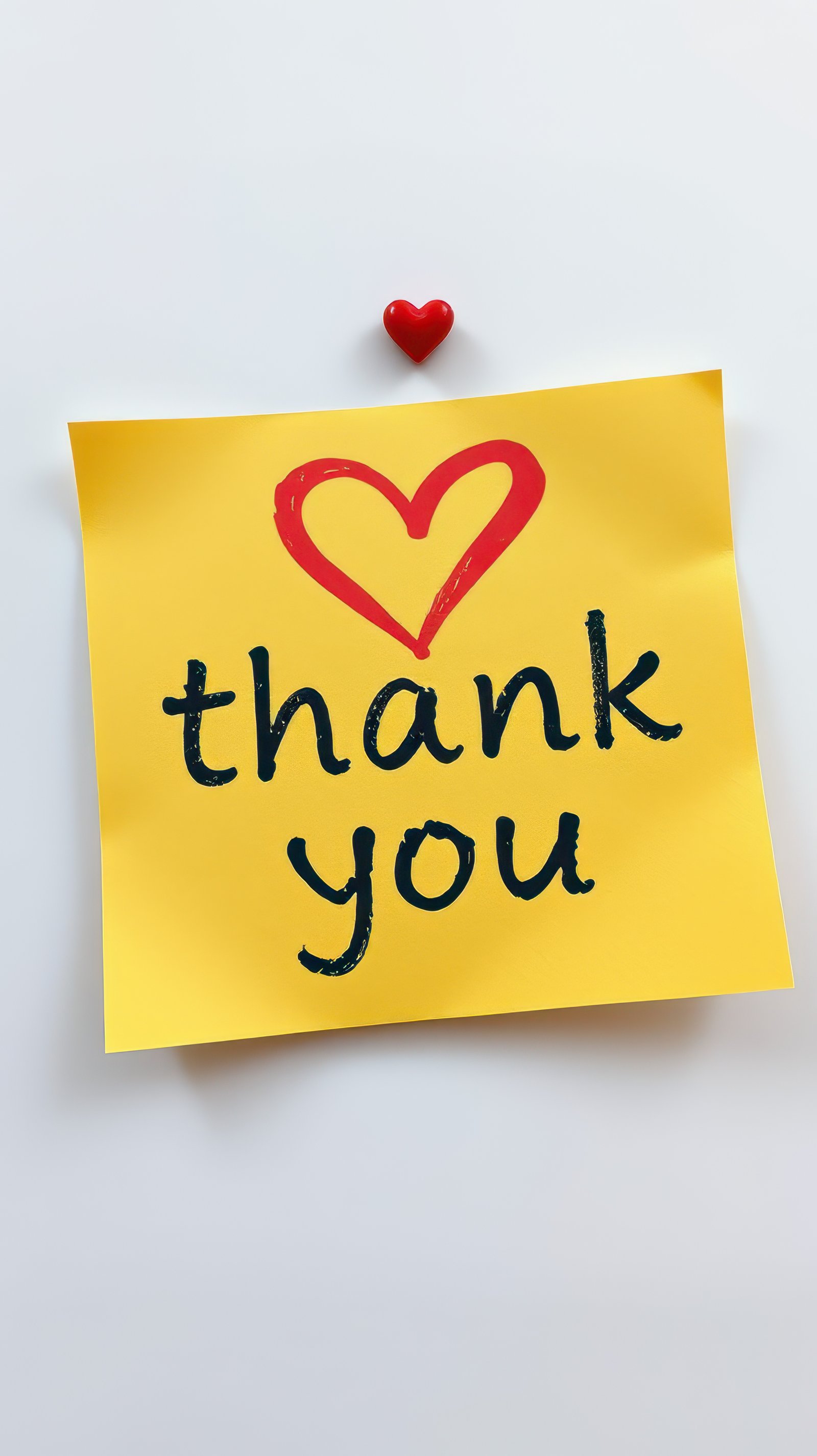 Heartfelt appreciation expressed on a sticky note adorned with a red heart in a simple setting